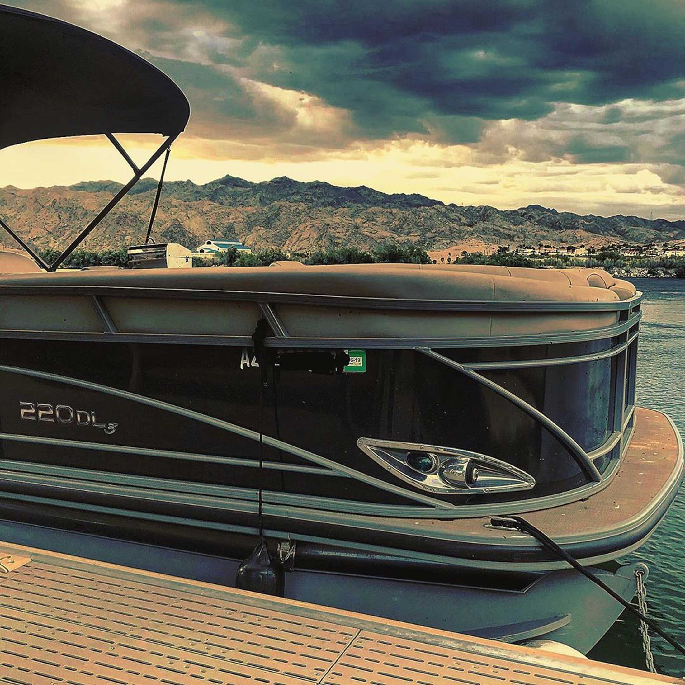 Side view of a docked 220 DL3 Pontoon 